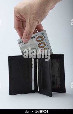 businessman saving money, Close up man carrying a wallet in hand, the dollar,finance accounting concept Stock Photo