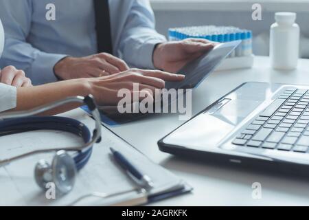 Сlose up of patient and doctor prescribing medication Stock Photo