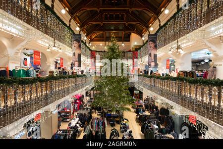 view of Christmas tree and decorations in atrium of Jenners department store on Princes Street in Edinburgh, Scotland, Uk