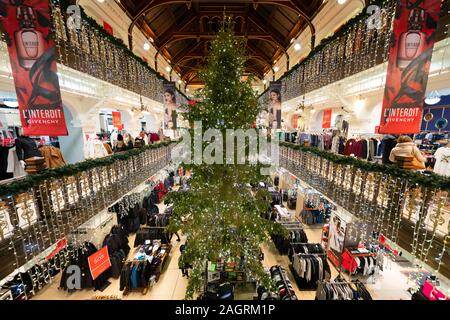 view of Christmas tree and decorations in atrium of Jenners department store on Princes Street in Edinburgh, Scotland, Uk