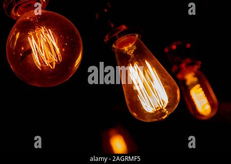 Modern, vintage style light bulbs in a dark public house Stock Photo