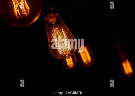 Modern, vintage style light bulbs in a dark public house Stock Photo