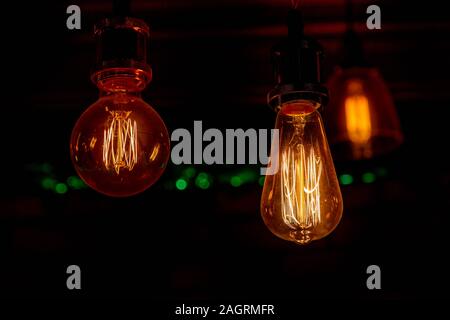 Modern, vintage style light bulbs in a dark public house Stock Photo