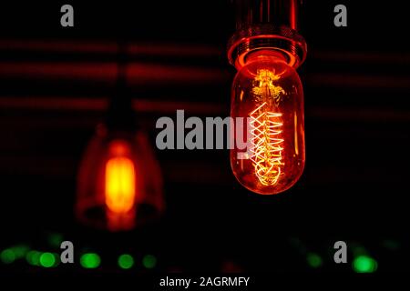 Modern, vintage style light bulbs in a dark public house Stock Photo