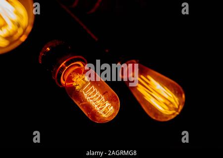 Modern, vintage style light bulbs in a dark public house Stock Photo