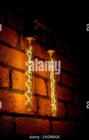 Modern, vintage style light bulbs in a dark public house Stock Photo