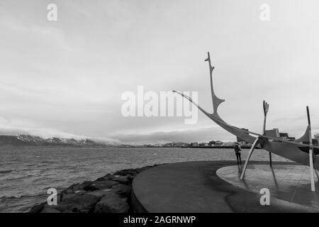 Black and white shot of the calm sea and the Sun Voyager sculpture in Reykjavik Stock Photo