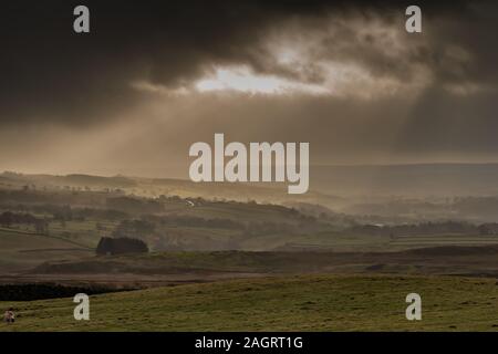 Rays of sunlight through a break in the clouds light up Eggleston, Teesdale Stock Photo