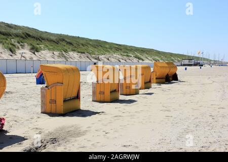 Roofed wicker beach chairs. Egmond aan Zee, North Sea, the Netherlands. Stock Photo