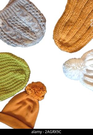 Different types of Knitted hat, yellow, green, white, gray on a white isolated background with copy space. View from above Stock Photo