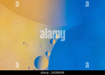 An abstract artistic close up macro photo created by mixing oil and water then back lit with a blue and orange flash Stock Photo