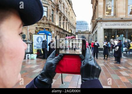 Glasgow, UK. 21 December 2019. On the last shopping Saturday before Christmas, thousands of customers flock to Glasgow City centre to enjoy the street entertainment provided by Govan branch of the Salvation Army, the international foods at the Street markets and the many executive shops in Buchanan Street, known as Glasgow's 'Style Mile'.  Credit: Findlay / Alamy News Stock Photo