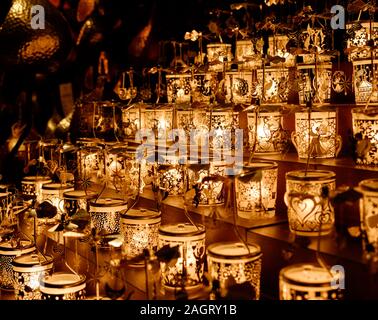Close up of Golden Christmas candle mobiles at Leicester Square Christmas market in the evening, Christmas time, Central London. Stock Photo