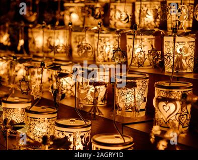 Close up of Golden Christmas candle mobiles at Leicester Square Christmas market in the evening, Christmas time, Central London. Stock Photo