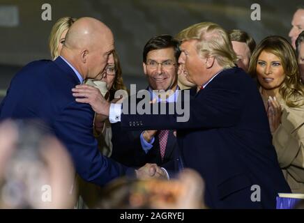 Suitland, Maryland, USA. 20th Dec, 2019. United States President Donald J. Trump congratulates US Space Force General John W. ''Jay'' Raymond, Commander of the US Space Force, left, after making remarks and signing S.1790, the National Defense Authorization Act for Fiscal Year 2020 at Joint Base Andrews in Suitland, Maryland on Friday, December 20, 2019. US Secretary of Defense Dr. Mark T. Esper looks on from center. First lady Melania Trump is visible at far right Credit: Ron Sachs/CNP/ZUMA Wire/Alamy Live News Stock Photo