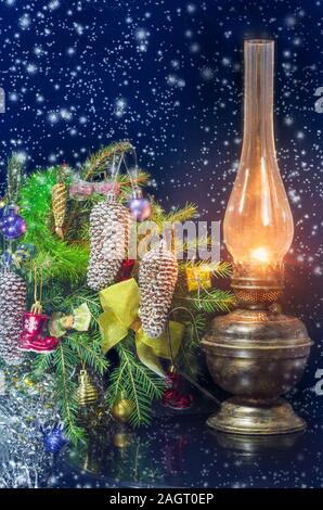 Beautiful Christmas card with decorated fir branches and old kerosene lamp Stock Photo