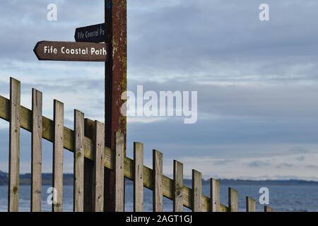 Fife Coastal Path wooden signpost with sea in background taken at Leven Beach, Fife, Scotland Stock Photo