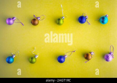 Christmas holidays composition, top view colored Christmas decorations on a yellow background with copy space for text. Flat lay. Winter, postcard Stock Photo