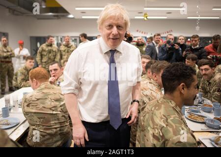 Prime Minister Boris Johnson meets soldiers after serving Christmas lunch to British troops stationed in Estonia during a one-day visit to the Baltic country. PA Photo. Picture date: Saturday December 21, 2019. The Prime Minister thanked the servicemen and women for their work as he joined them for lunch at the Tapa military base near the capital Tallinn. The base is home to 850 British troops from the Queen's Royal Hussars who lead the Nato battlegroup along with personnel from Estonia, France and Denmark. See PA story POLITICS Estonia. Photo credit should read: Stefan Rousseau/PA Wire Stock Photo