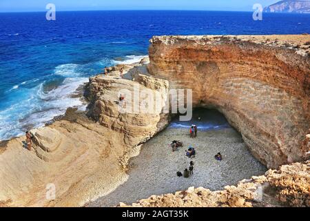 the famous Gala beach at Ano Koufonisi island Greece - the sea enters the beach via a narrow corridor of the open cave of the rocks - Gala means milk Stock Photo