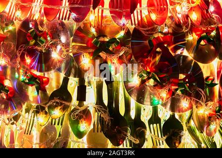 Close-up of a Christmas decoration of recycled utensils and compact discs combined with warm Christmas lights, seen in the Philippines Stock Photo