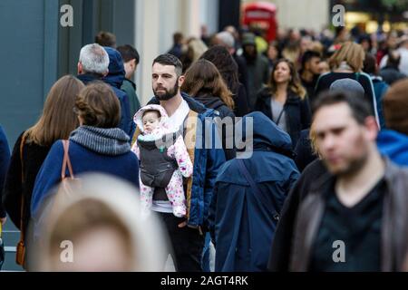 Bath, Somerset, UK. 21st December, 2019. Shoppers in Bath city centre are pictured as they visit the shops on the last Saturday before Christmas. The last Saturday before Christmas has become known as ‘Panic Saturday' and many stores have  reduced prices to attract last minute customers. Credit: Lynchpics/Alamy Live News Stock Photo