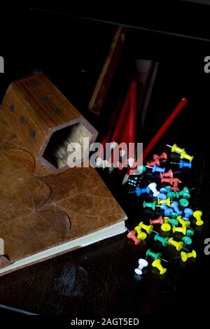 assorted push pins witk wooden pen holder and leather agenda Stock Photo