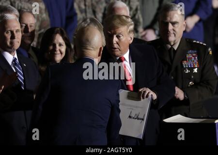 Suitland, Maryland, USA. 20th Dec, 2019. United States President Donald J. Trump congratulates US Space Force General John W. ''Jay'' Raymond, Commander of the US Space Force, left, after making remarks and signing S.1790, the National Defense Authorization Act for Fiscal Year 2020 at Joint Base Andrews in Suitland, Maryland on Friday, December 20, 2019. Also visible from left to right: US Vice President Mike Pence, Karen Pence, and US Army General Mark A. Milley, Chairman of the Joint Chiefs of Staff Credit: Yuri Gripas/CNP/ZUMA Wire/Alamy Live News Stock Photo