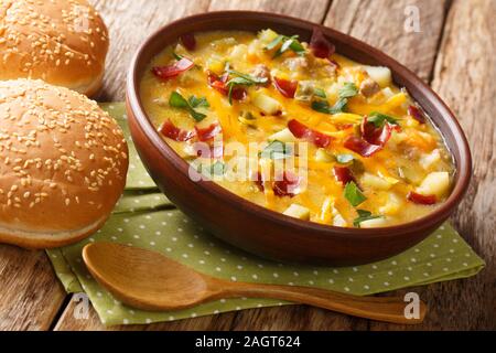 Hearty cheeseburger soup with vegetables, beef, bacon and cheese close-up in a bowl on the table. horizontal Stock Photo