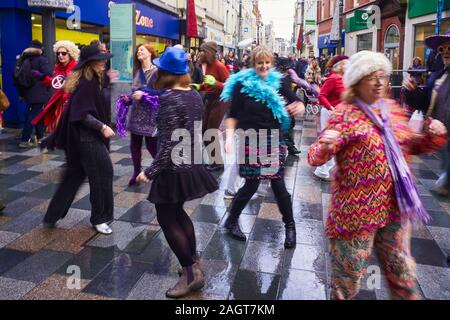 Members of the Isle of Man extinction rebellion group dancing in Strand Street to Staying Alive during peak Christmas Shopping on Saturday 21 December Stock Photo