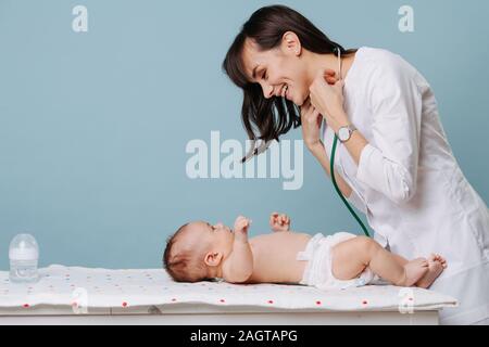 pediatrician doctor communicates and plays with baby Stock Photo