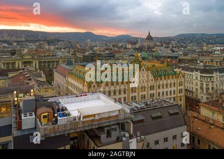 Amazing roof in Budapest, Hungary. State Treasury building with Hungarian Parliament in winter time.    All tiles on the roof made from the world famo Stock Photo