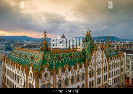 Amazing roof in Budapest, Hungary. State Treasury building with Hungarian Parliament in winter time.  All tiles on the roof made from the world famous Stock Photo