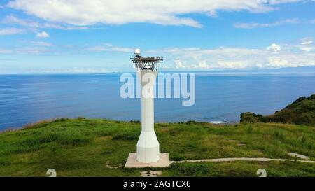 Basot Island, Caramoan, Camarines Sur, Philippines. Lighthouse on a tropical island. Lighthouse on the hill. Beautiful landscape with a green island. Summer and travel vacation concept. Stock Photo