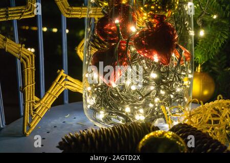 abstract view of colorful Christmas decorations in vase with heart-shaped baubles and gold star Stock Photo