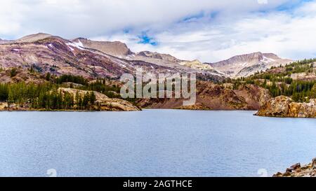 The clear glacial water of Tioga Lake at an elevation of 2938m on Tioga Pass in the eastern part of Yosemite National Park, California, United States Stock Photo