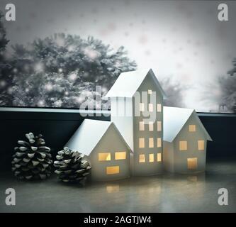 Beautiful winter landscape with small houses made of paper illuminated inside and with pine cones and window with some trees and snow Stock Photo