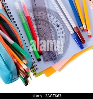 Various school supplies including notebooks and pencil case isolated against a white background Stock Photo