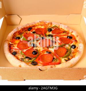 Freshly baked Italian pepperoni Pizza in a delivery box isolated on a white background. Stock Photo