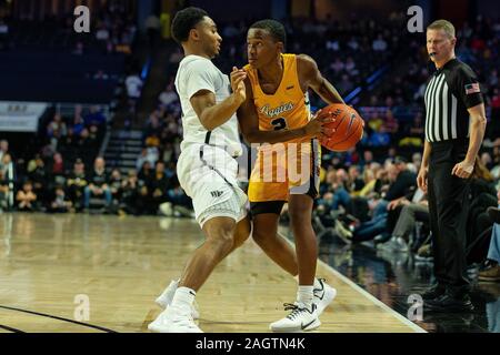 Winston-Salem, NC, USA. December 21, 2019: Wake Forest Demon Deacons guard Brandon Childress (0) defends North Carolina A&T Aggies guard Fred Cleveland Jr. (2) during the second half of the NCAA Basketball matchup at LJVM Coliseum in Winston-Salem, NC. (Scott Kinser/Cal Sport Media) Stock Photo