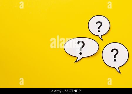 Three different shaped speech bubbles over a bright yellow background Stock Photo
