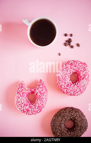 Tasty and delicious donuts with different icing and filling on a colored background with coffee.Donuts on link background Stock Photo