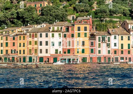 Colourful old buildings on the waterfront with moored boats in Portofino on the Italian Riviera, Liguria Italy, a popular tourist destination Stock Photo