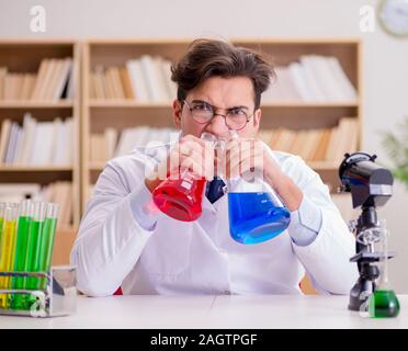 The mad crazy scientist doctor doing experiments in a laboratory Stock Photo