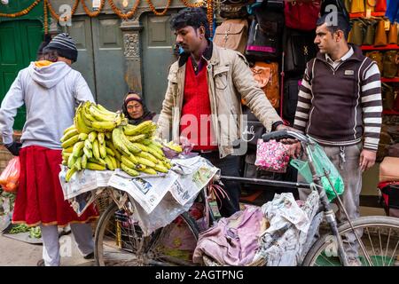 Kathmandu, Nepal - November 17, 2018: Fruit seller on a bicycle sells bananas on the Kathmandu streets. Stock Photo