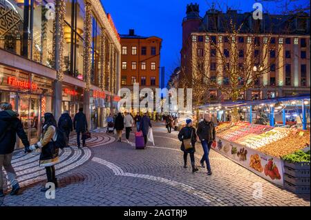 Sweden, Stockholm, December 18, 2019: Christmas atmosphere of the city. Market stalls with flowers, fruit, vegetables and souvenirs at the Hotorget sq Stock Photo