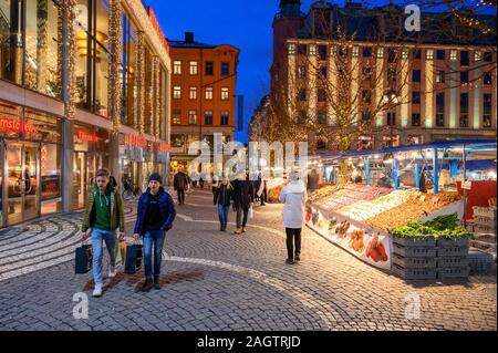 Sweden, Stockholm, December 18, 2019: Christmas atmosphere of the city. Market stalls with flowers, fruit, vegetables and souvenirs at the Hotorget sq Stock Photo