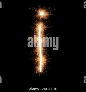Lower case i letter of alphabet written by squib sparks on a black background. Stock Photo