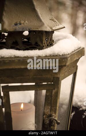 Detail burning Candle in a brown lantern with snow by jziprian Stock Photo