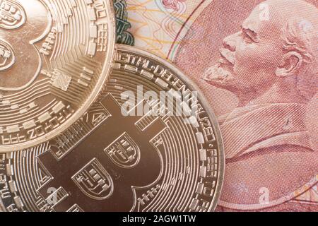 Two Bitcoin coins lie on top of Soviet paper money rubles with the symbol of the USSR Lenin. Concept for articles and posts about past and future mone Stock Photo